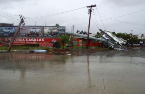 Power lines and debris are knocked over on a street after Hurricane Odile hit La Paz